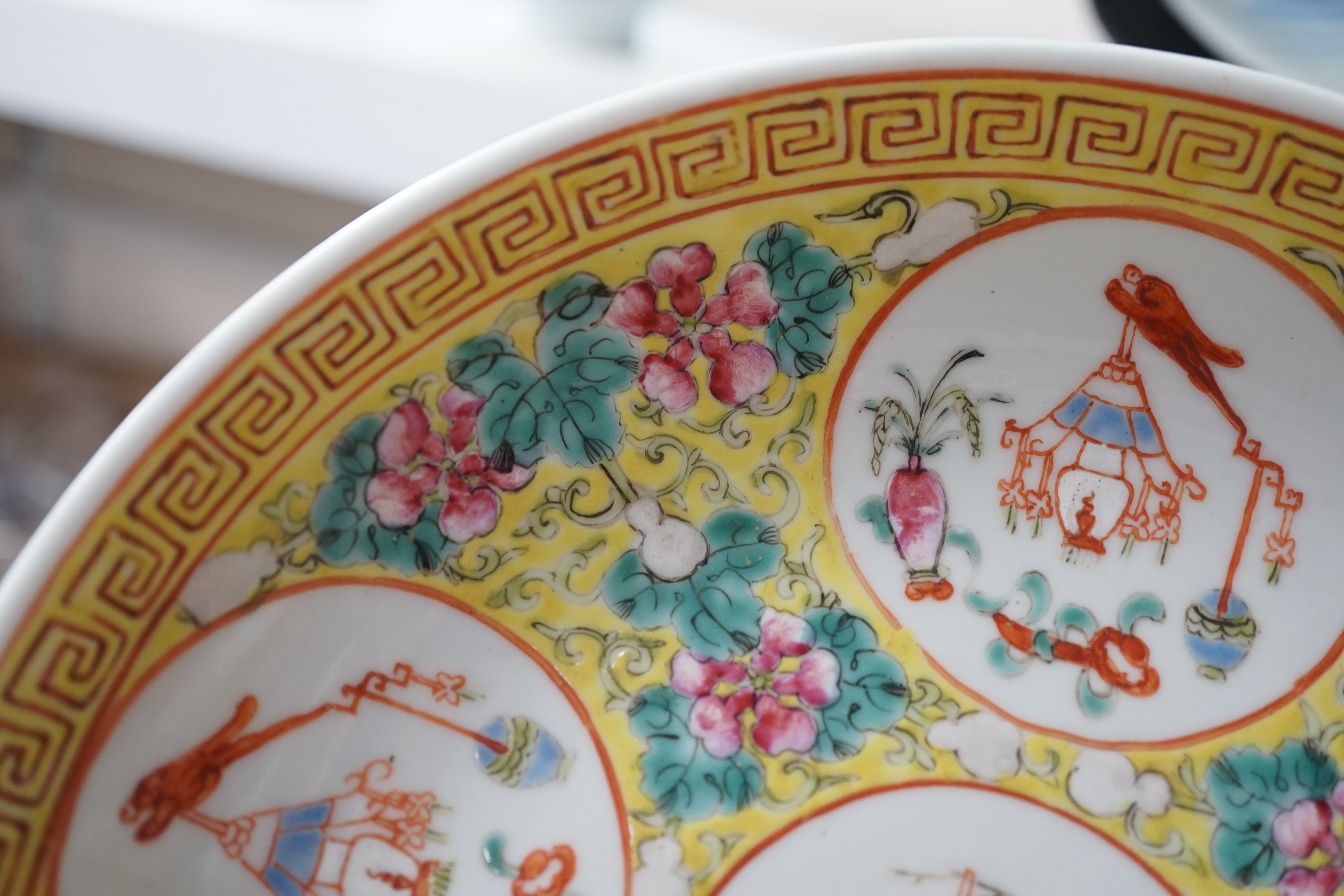 A pair of Chinese yellow ground medallion saucer dishes, Guangxu six character marks, early 20th century, hairline crack to one dish